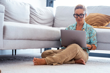 Senior woman relaxed at home, comfortable with technology 2055515485